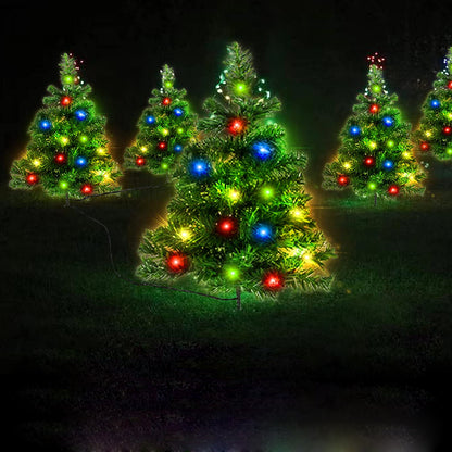 Multicolored LED solar Christmas tree pathway lights glowing outdoors at night
