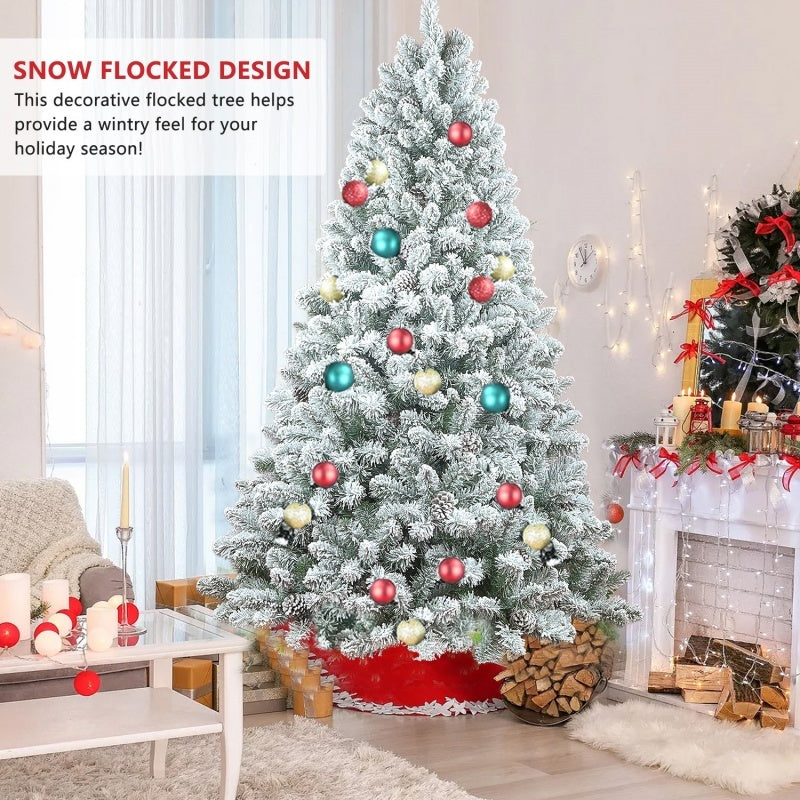 6ft snow flocked Christmas tree decorated with red, gold, and teal ornaments in cozy living room