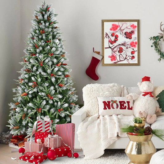 5.4ft artificial PVC Christmas tree with snow flocking, red berries, pine cones and red gift boxes near white cozy sofa with Noel pillow