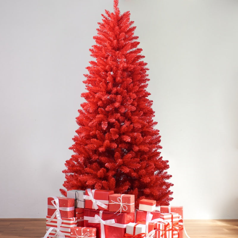 Red artificial PVC Christmas tree with red and white wrapped gift boxes on wooden floor