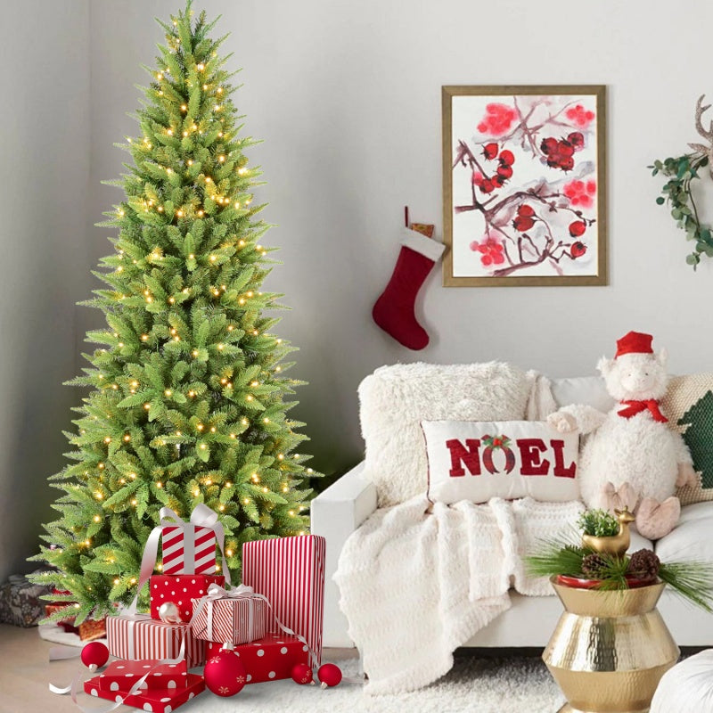 4ft artificial Christmas tree with warm white LED lights in living room with presents, Noel pillow, and festive decor