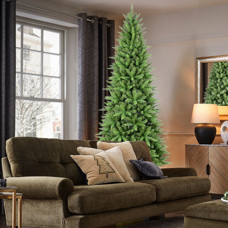 4ft artificial PVC Christmas tree with 424 tips in a cozy living room beside a brown sofa and lamp
