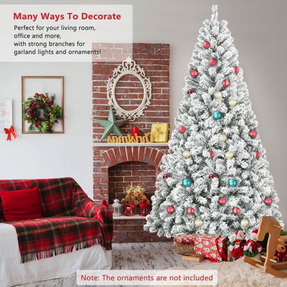 4ft snow flocked artificial Christmas tree decorated with colorful ornaments in cozy living room with plaid blanket and wooden toys