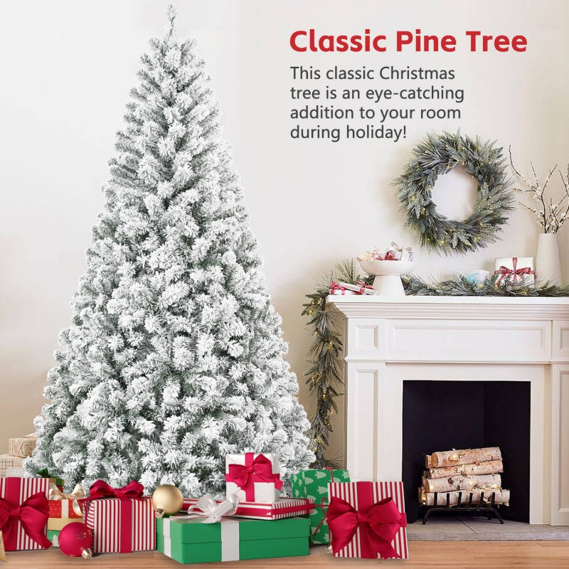 Snow flocked artificial Christmas pine tree decorated with presents near a white fireplace and wreath