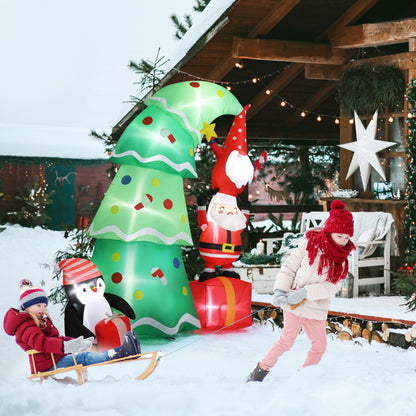 Child pulling a sled with another child sitting, inflatable Christmas tree, Santa, and penguin decorations in snowy yard
