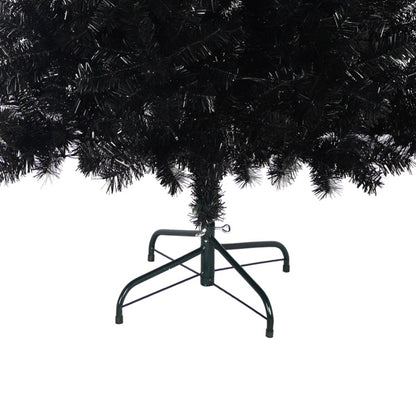 Close-up of black artificial Christmas tree base with green metal stand and dense branches