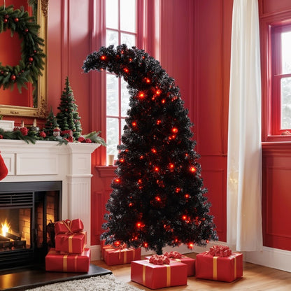 Black artificial Christmas tree with red lights and curved top in red living room near fireplace with wrapped gifts