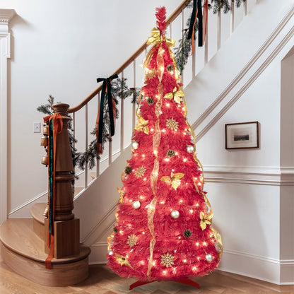 6ft pink pre-lit Christmas tree decorated with gold ribbons, ornaments, and snowflakes near stair railing