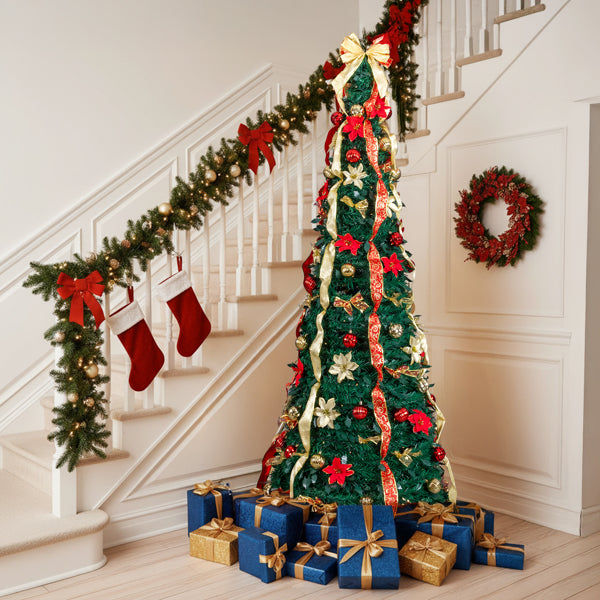 Pre-lit slim Christmas tree with red poinsettias, gold ornaments, ribbons, and blue and gold wrapped gifts in living room