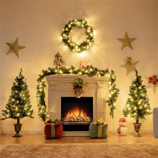 Cozy Christmas scene with lit wreath, garland on fireplace, two decorated trees, gifts and snowman.