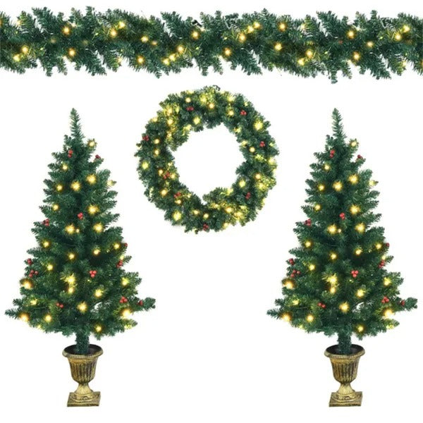 Christmas decor set with two potted lit trees, a wreath, and a garland with warm white lights