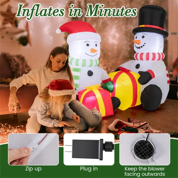 Mother and child with festive inflatable snowmen and LED light gift boxes indoors