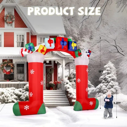 9ft inflatable LED Christmas sock arch decorated with gifts and snowflakes in snowy yard