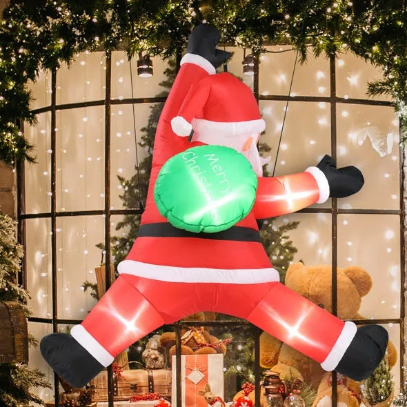 Inflatable LED Santa Claus decoration holding green Merry Christmas sign on festive window display