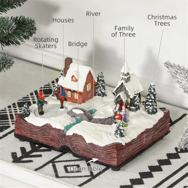 Animated LED resin Christmas village decoration with houses, rotating skaters, a bridge over a river, a family of three, and Christmas trees on an open book base
