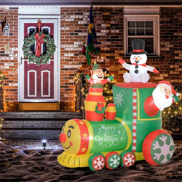 Inflatable Christmas train with snowman, elf, and Santa in front of brick house with wreath door