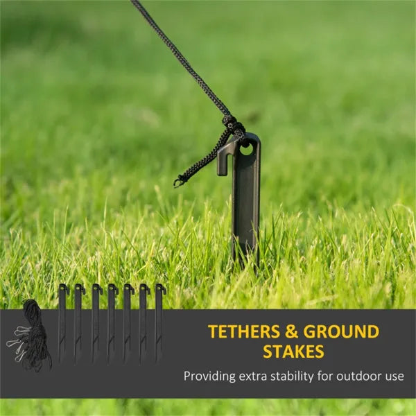Black ground stakes with attached tethers on grass for outdoor stability