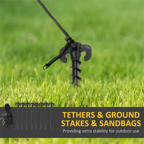 Black plastic ground stake with rope tether securing outdoor item in grass for stability