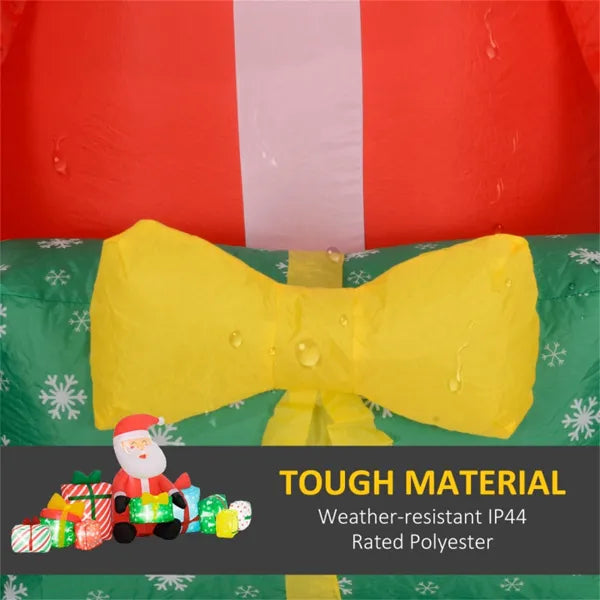 Close-up of yellow bow detail on inflatable Christmas decoration with water droplets, showcasing tough weather-resistant material