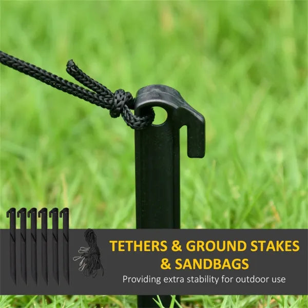 Black ground stake with attached tether rope in green grass, outdoor stability accessories for decorations