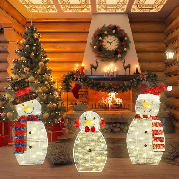 Indoor cozy Christmas scene with LED lighted snowman family, decorated tree, and lit fireplace