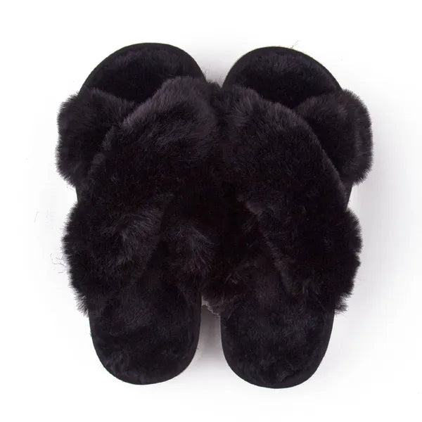 Pair of black faux fur slippers with crossed straps and soft cushioned sole