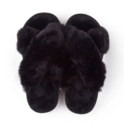 Pair of black faux fur slippers with crossed straps and soft cushioned sole