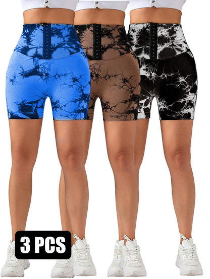 Three women wearing high-waisted tie-dye butt lifting shorts in blue, brown, and black-white, with white sneakers