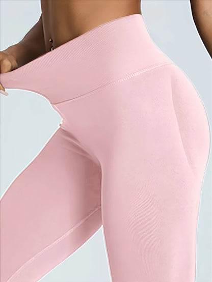 Close-up of woman wearing light pink seamless tummy control leggings stretching waistband