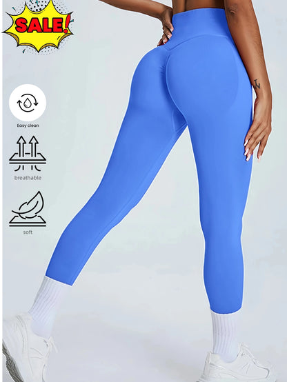 Woman wearing bright blue high-waisted seamless leggings with tummy control, posing in white sneakers