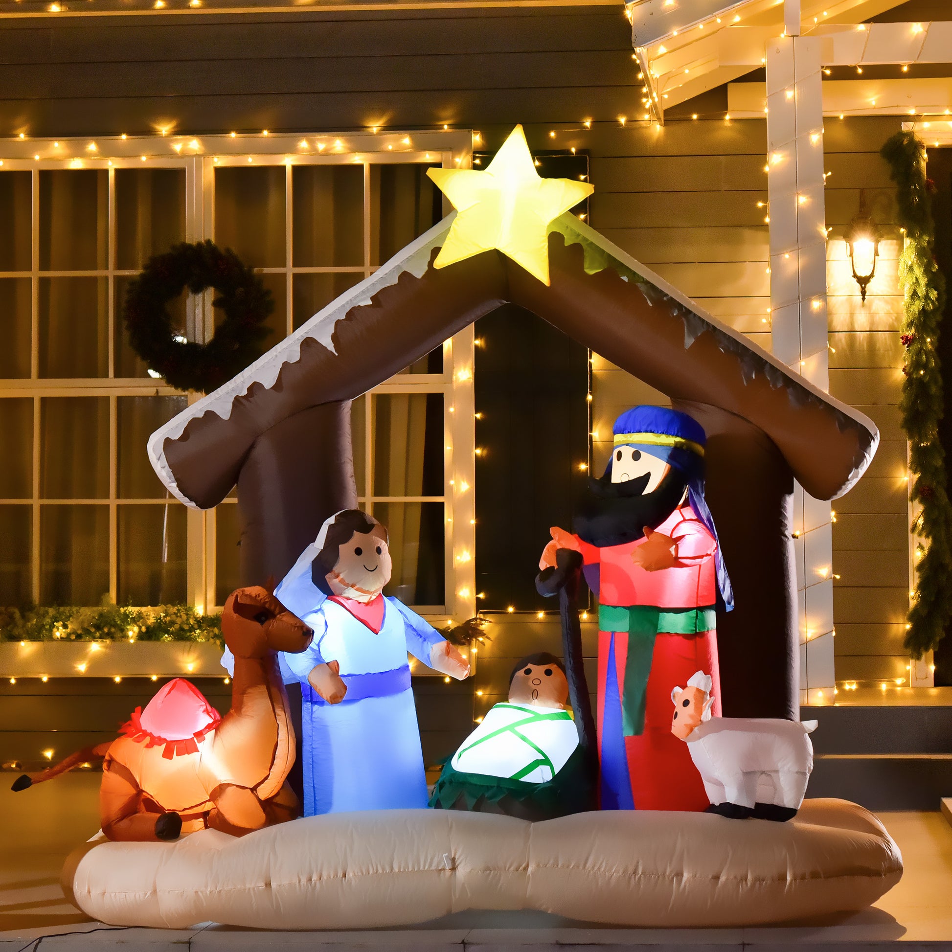 Inflatable LED-lit Christmas nativity scene with Mary, Joseph, baby Jesus, camel, and sheep under a star