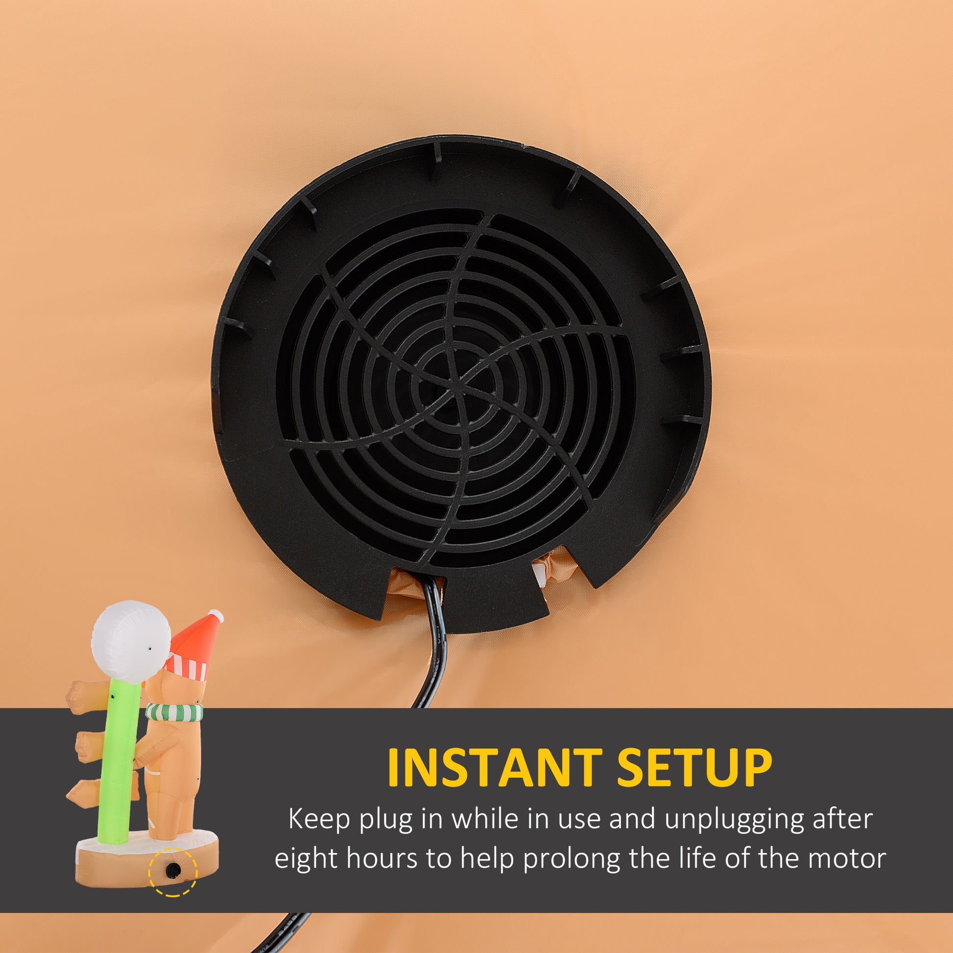 Black circular fan motor vent with power cord on brown inflatable Christmas gingerbread man