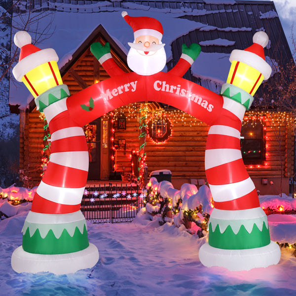 Inflatable 8-9ft Christmas arch with Santa and candy cane pillars glowing in snowy front yard