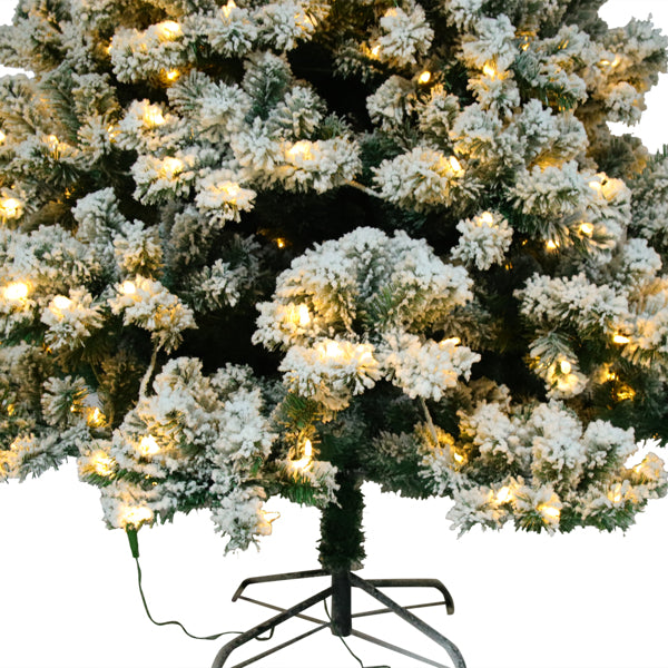 6ft flocked Christmas tree with 928 tips and warm white lights on a metal stand