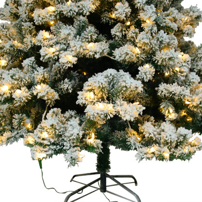 6ft flocked Christmas tree with 928 tips and warm white lights on a metal stand