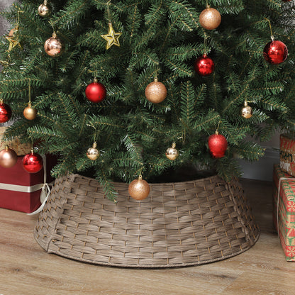 Christmas tree with red and gold ornaments in a rustic woven coffee-colored tree collar on wooden floor