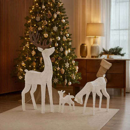 Lighted reindeer family set with warm white LED lights in cozy living room with Christmas tree