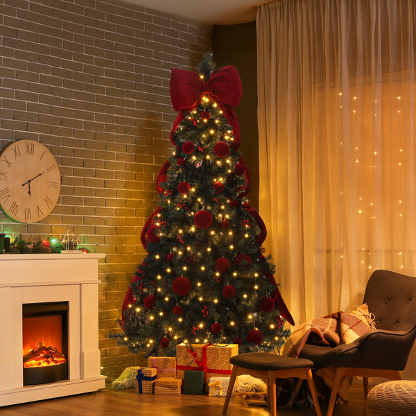 7.5 ft artificial Christmas tree with red ornaments and warm white LED lights in cozy living room