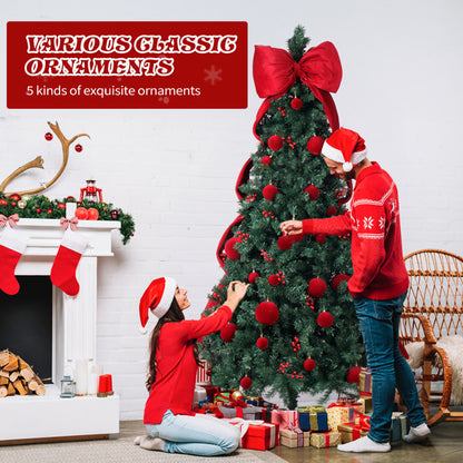 Couple in Santa hats decorating a Christmas tree with red ornaments and gifts beside a festive fireplace