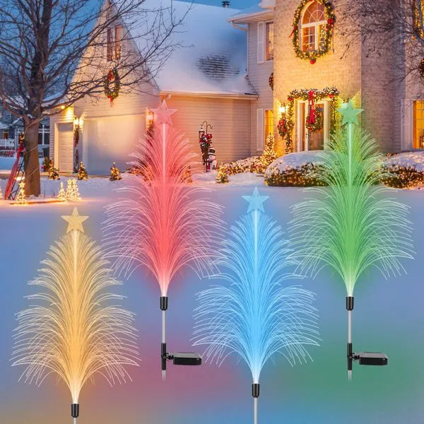 Colorful solar-powered fiber optic cedar tree lights in yellow, red, blue, and green in snowy outdoor holiday decor