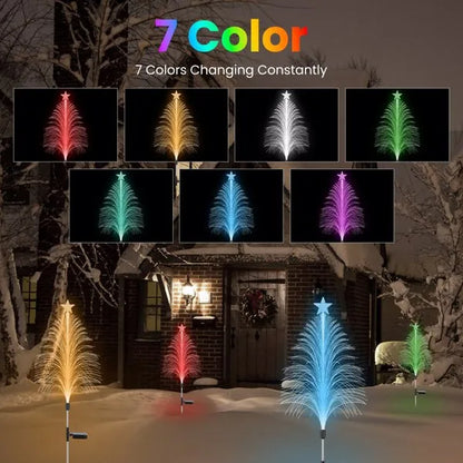 7 color changing solar fiber optic cedar tree lights with star tops in a snowy outdoor house yard