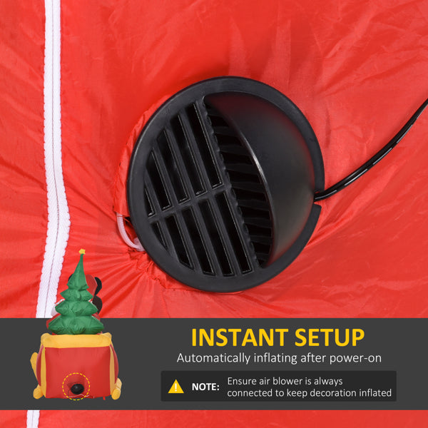 Black air blower inflating red fabric of inflatable Christmas yard decoration with instant setup instructions