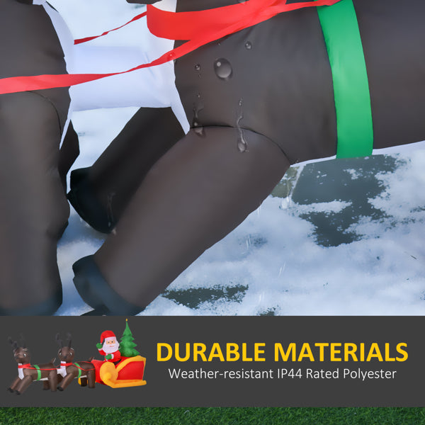 Close-up of black inflatable Santa sleigh leg with water droplets on snow-covered ground