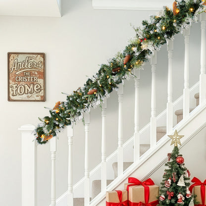Snow flocked Christmas garland with warm lights and pine cones on white staircase railing, holiday decor