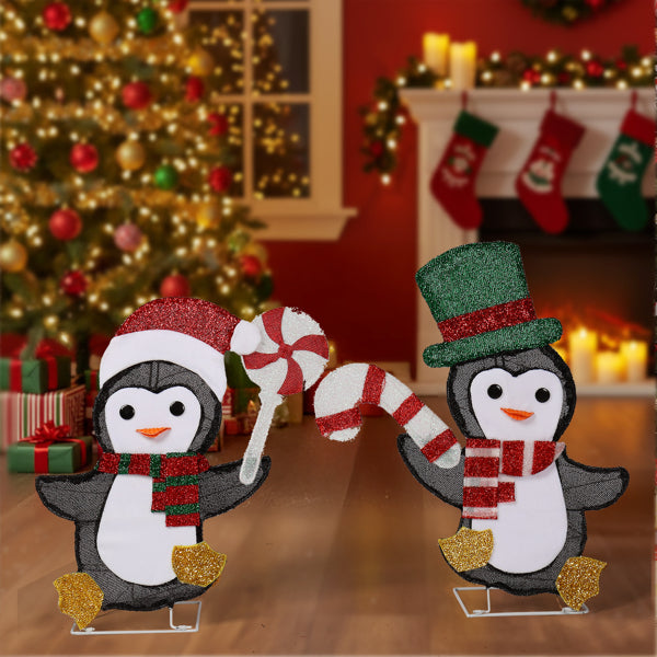 Christmas decoration featuring two glittery penguins with candy cane and peppermint, festive living room setting