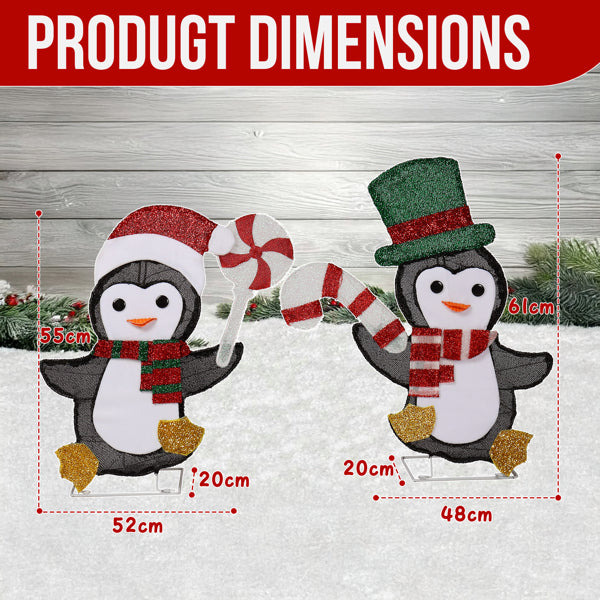 Two glittery penguin Christmas decorations with candy cane, one wearing Santa hat and scarf, the other with top hat and scarf