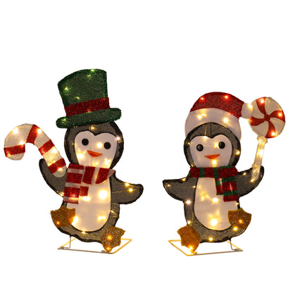 LED lighted Christmas penguin decorations with candy cane, green top hat, and red Santa hat
