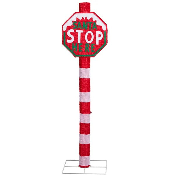 Red and white lighted Christmas yard sign reading Santa Stop Here with striped pole and metal base