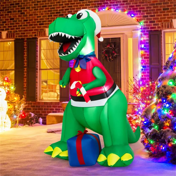 6ft green inflatable Christmas dinosaur wearing Santa hat and red sweater, holding candy cane, with present on snow