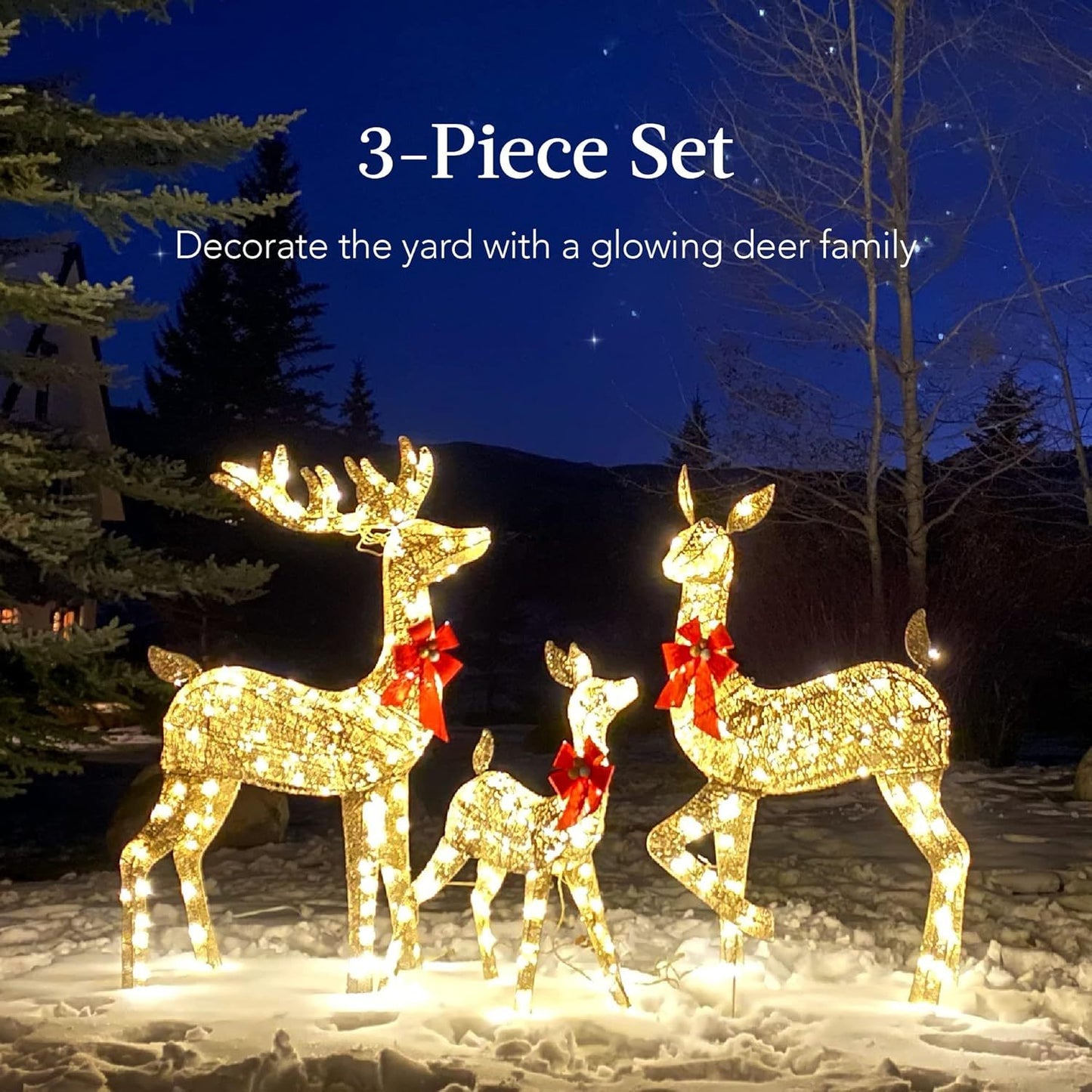 Glowing three-piece outdoor golden reindeer set with red bows in snowy yard at night